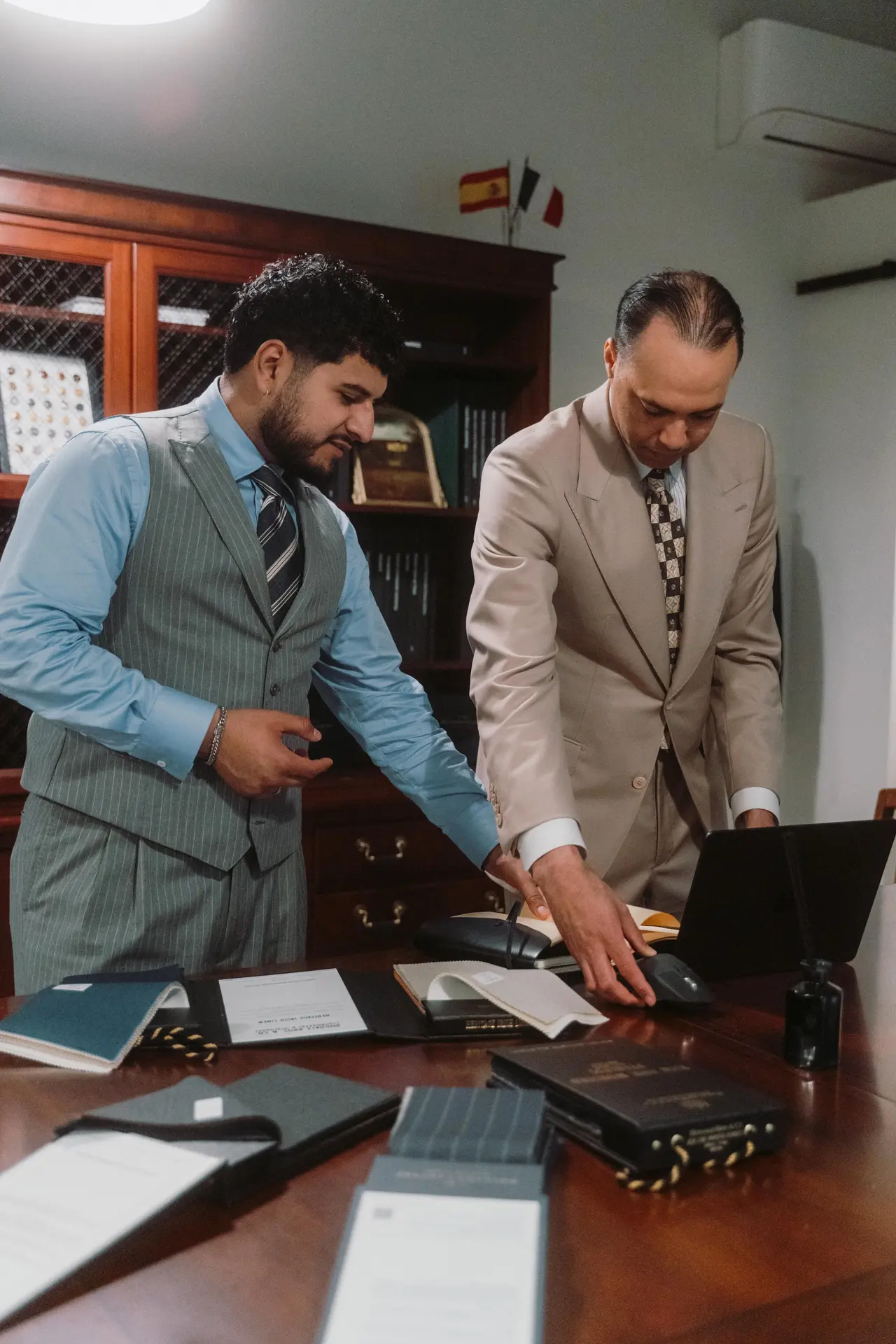 Julian and David reviewing cloth books at the studio desk