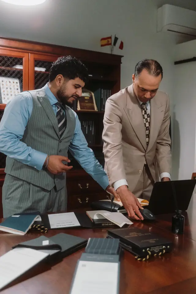 Julian and David reviewing cloth books at the studio desk