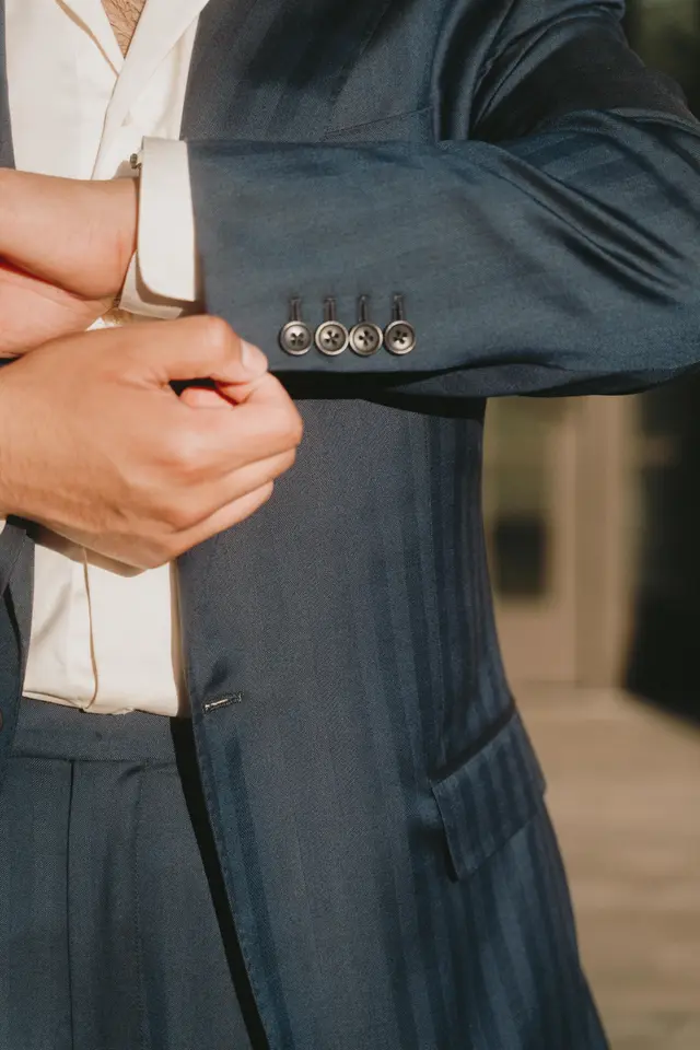 Detail of cuff buttons on a navy striped jacket