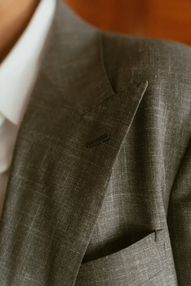 Close view of a grey peak lapel and pocket square