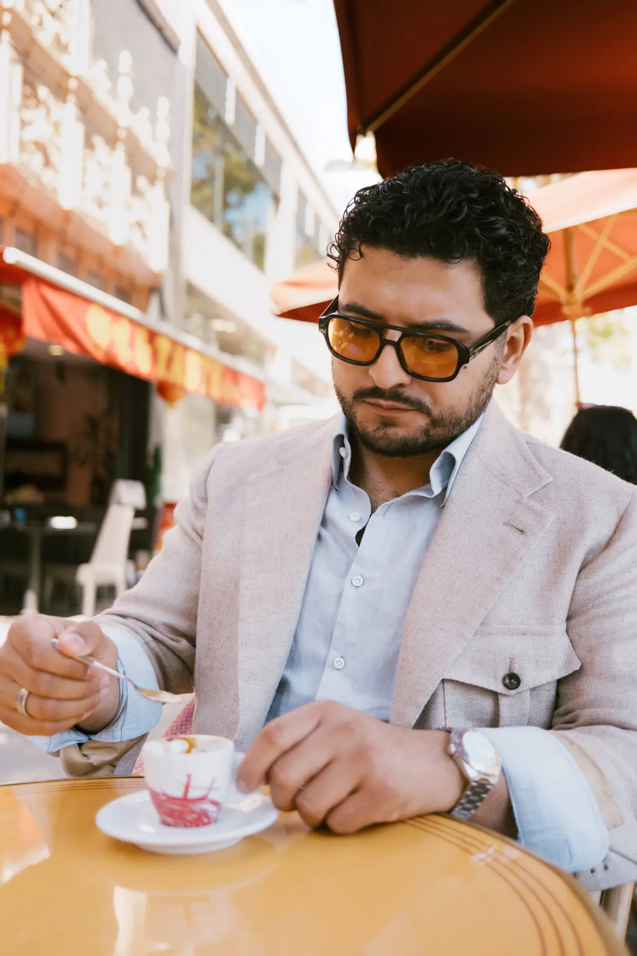 Julian in a linen jacket at a café